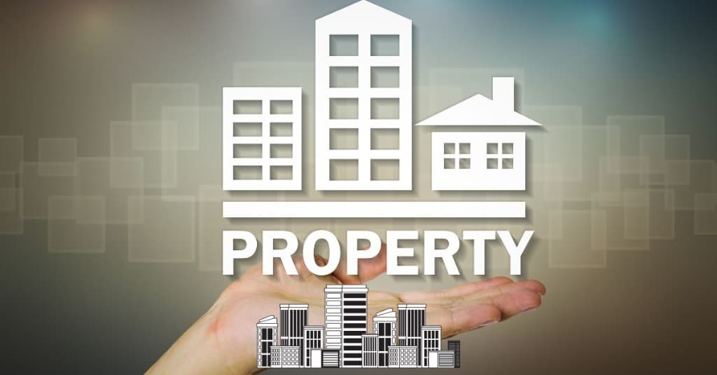 Graphic of buildings and the word Property supported in an open hand, representing property protection and ownership